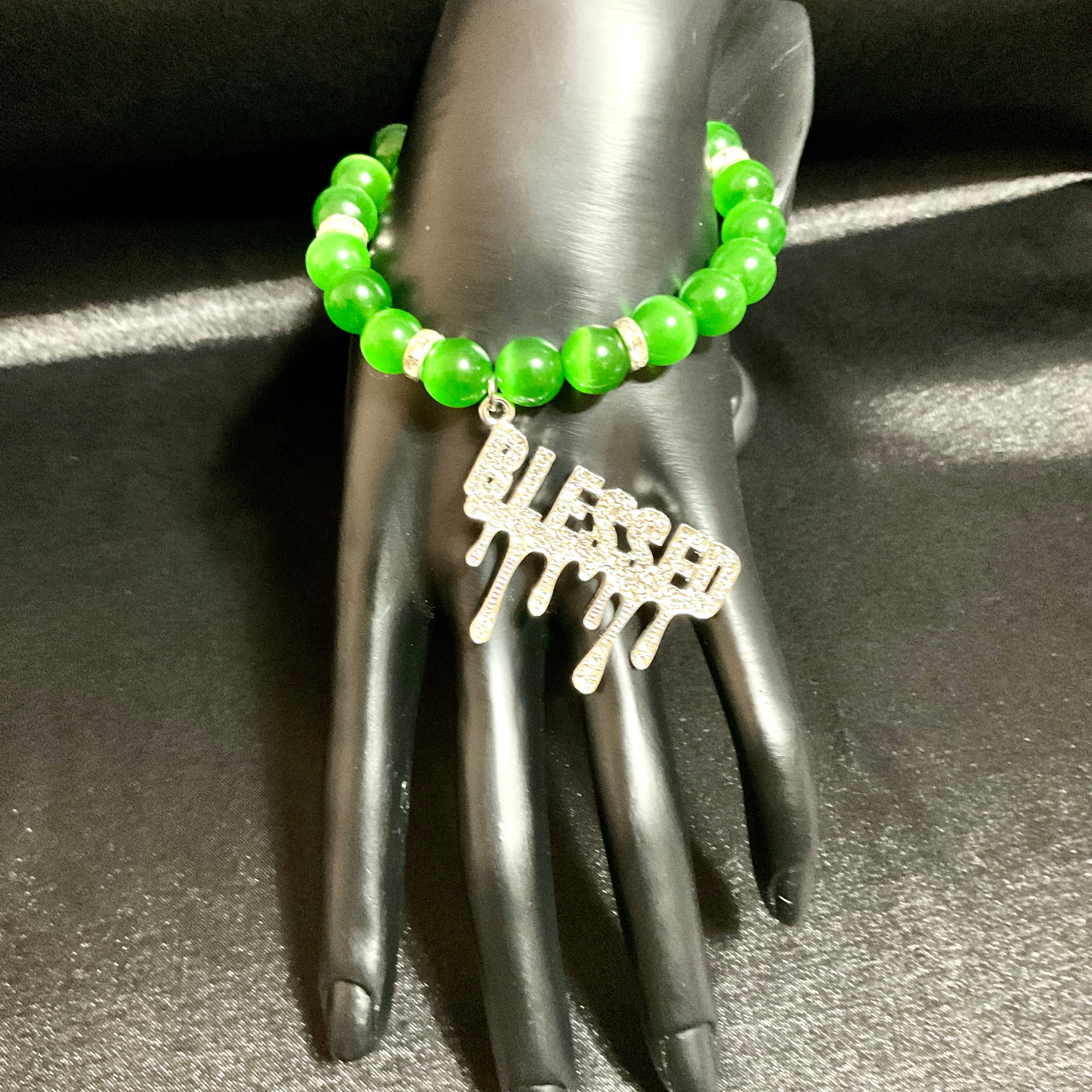 green bracelet with blessed charm
